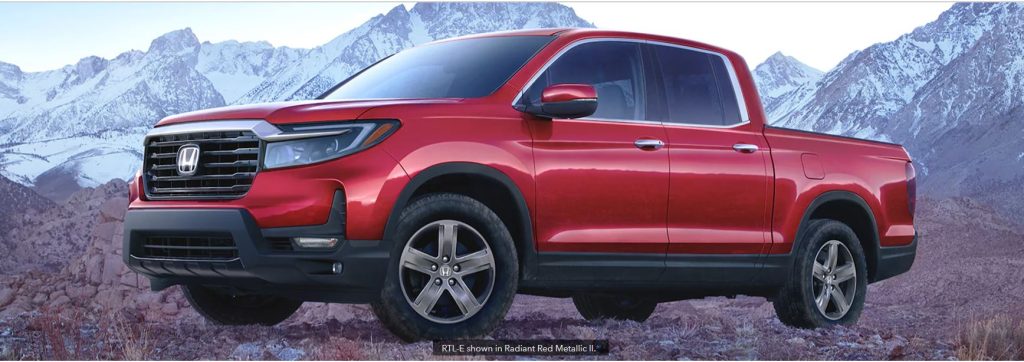 2022 Honda Ridgeline in metallic red. Picture taken by the mountains .