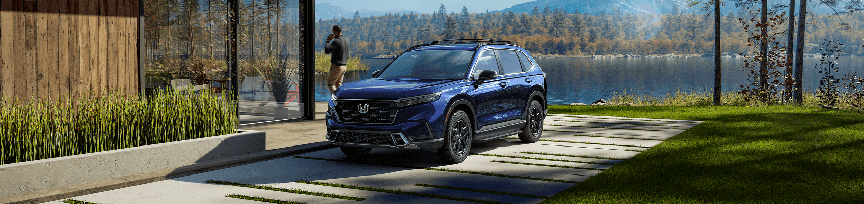 Honda SUV parked by lake house