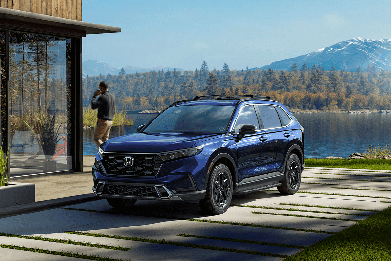 Honda SUV parked by lake house